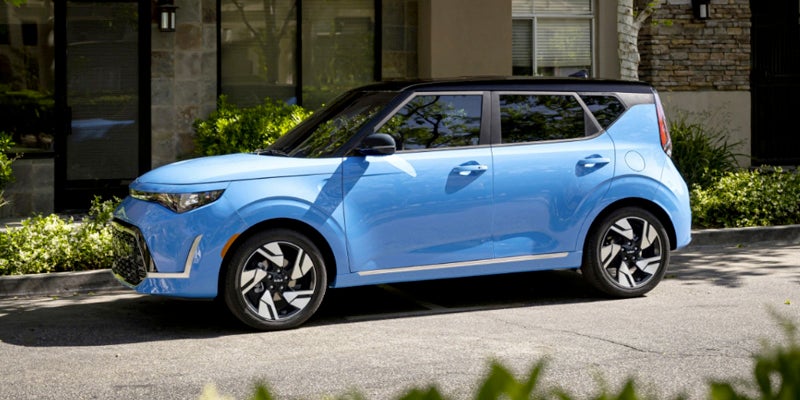 Side view of a blue 2023 Kia Soul parked on the side of a street